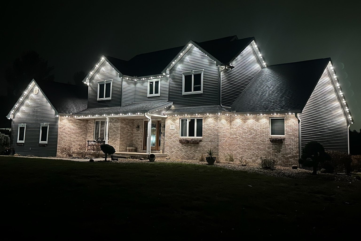Permanent warm-white LED lighting on a Central Coast home at dusk