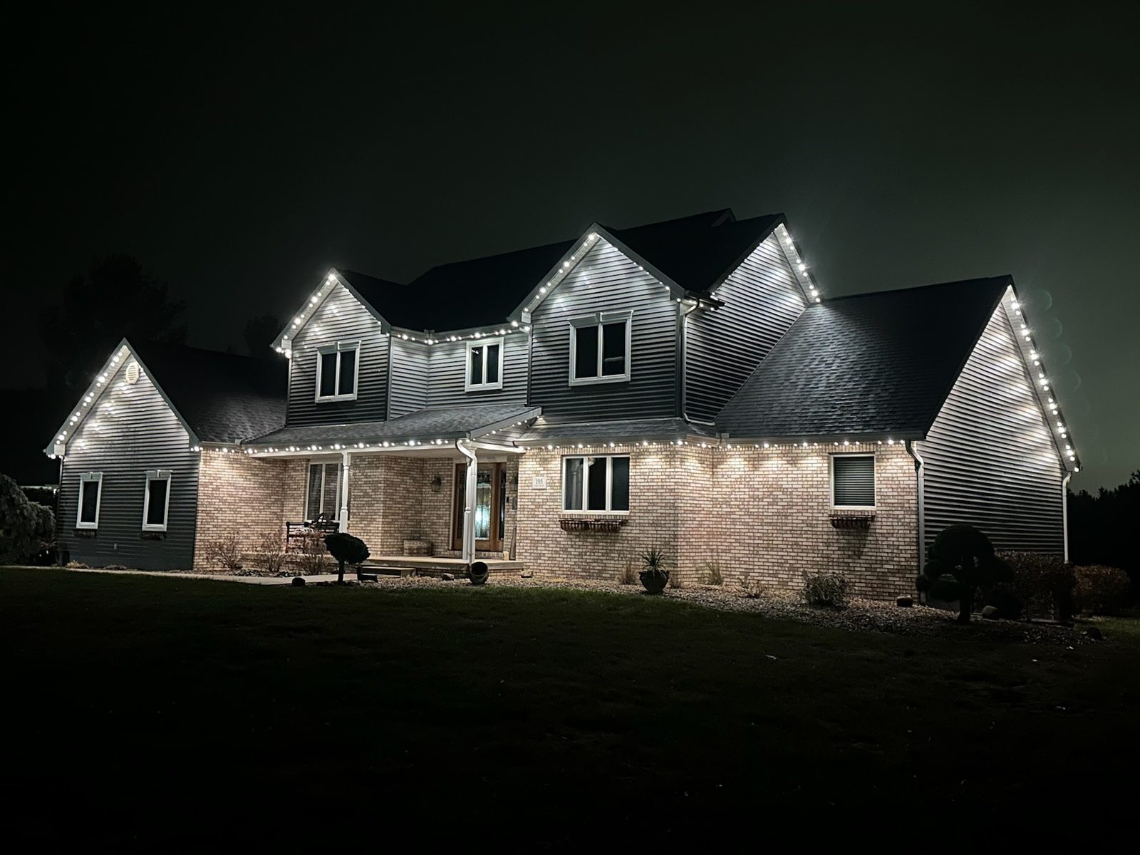 Cool white lighting on a two-story home