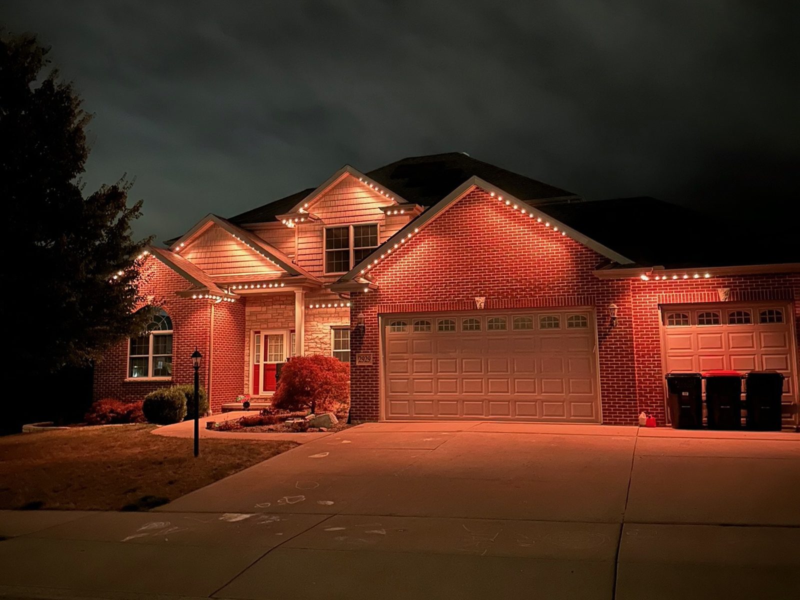 Orange accent lighting on a brick home