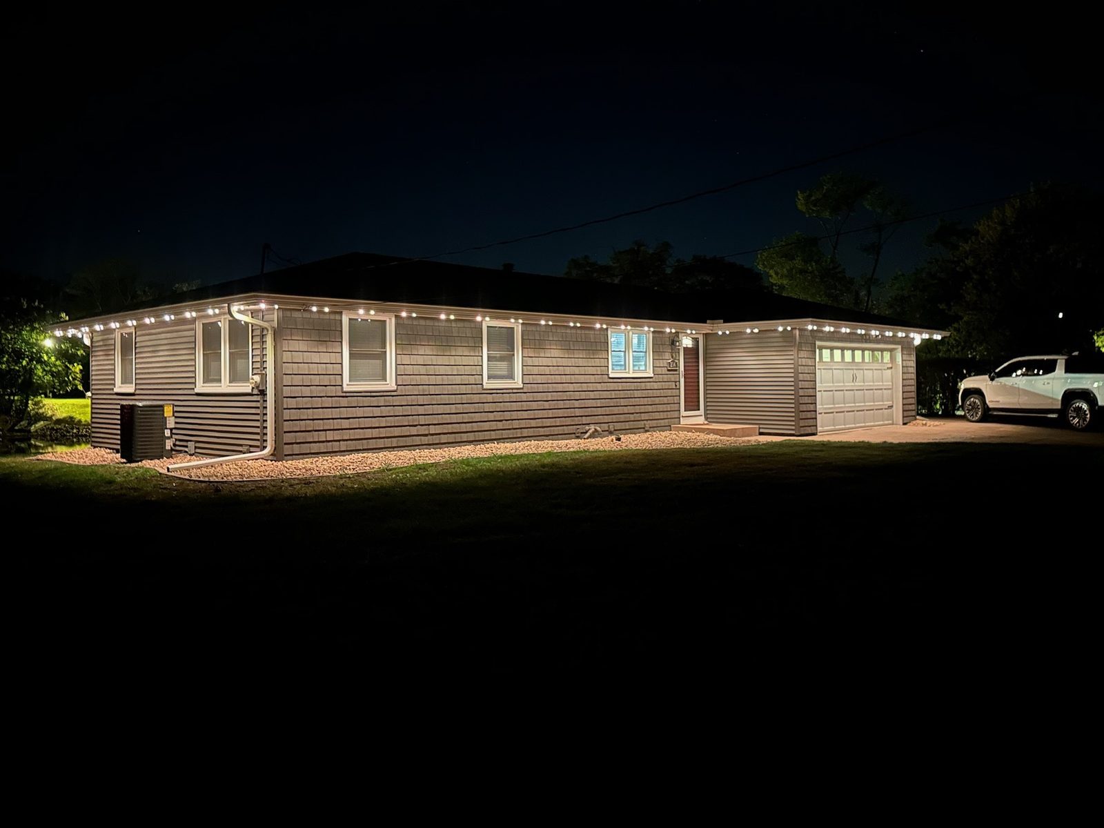 Warm white lighting along a ranch-style roofline